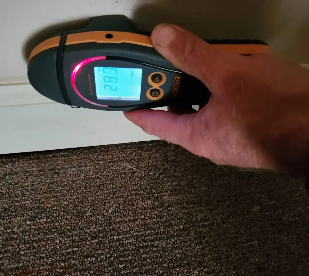 Moisture detection at baseboard during Storm Damage Restoration in Knightdale